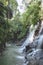 scenic view of beautiful Kanto Lampo Waterfall, green plants and rocks,