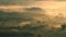 Scenic view of beautiful mountains with fog moving at sunrise. Sea of fog in winter early morning on peak of mountains.