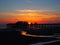 Scenic view of blackpool north pier in glowing red evening light at sunset with illuminated pink and yellow sky and clouds