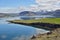 Scenic view with blue large Icelandic lake and mountains typical for Iceland