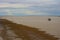 Scenic view of a boat on the Mudflats at Derby Wharf, Western Australia on a cloudy afternoon