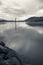 Scenic view on boat pole in atlantic ocean in long exposure with mountain jaizkibel in black and white, basque country, france