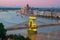 Scenic view of Budapest citylights from Castle Hill with Danube river, Chain Bridge and Parliament Building at twilight