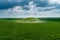 Scenic view of the burial mound of the Scythian king in a green field. Aerial view