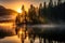 Scenic view of calm mountain lake on foggy autumn sunrise. Majestic pine trees on lake shores on a backdrop of setting sun