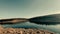 Scenic view of a calm reflective lake under the clear sky