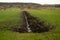 Scenic view of a canal flowing through a green marshland in the countryside