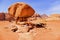 Scenic View Caravan of Camels Resting in the Shade of Mushroom Shaped Rock in Wadi Rum Desert, Jordan