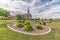 Scenic view of church with white steeple and landscaped yard on a cloudy day