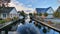 scenic view of countryside, houses on two sides of river banks