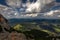 Scenic view with dark, blue, cloudy, sky from Rax plateau, Schneeberg massif, on valley with Puchberg village