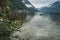 Scenic view of famous Hallstatt lakeside and pleasure boat reflecting in Hallstattersee lake in the Austrian Alps