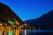 Scenic view of famous Hallstatt lakeside town reflecting in Hallstattersee lake in the Austrian Alps night time in summer,