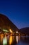 Scenic view of famous Hallstatt lakeside town reflecting in Hallstattersee lake in the Austrian Alps night time in summer,