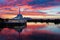 Scenic view of floating mosque on river with sunset background