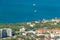 Scenic view of Gelendzhik city district and sea bay. Sunny day. Buildings, coast, ships in Black sea and horizon in