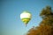 Scenic view of a green hot-air balloon flying in the blue sky in Natchez, Mississippi