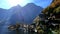 The scenic view of Hallstatt includes towering churches, and clouds and mists surrounding the lake and the mountains.