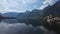 Scenic view of Hallstatt town, old town in Salzkammergut region, Austria with lake, mountain, church tower in background.