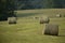 Scenic view of hay bales in green Midwest fields on a sunny day