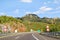 Scenic view on highway road leading through in Croatia, Europe / Electrical transmission towers, sky and clouds in background.