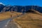 Scenic view of a highway winding its way through a mountain range on a sunny day in Kazbegi, Georgia