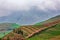 Scenic view of hillside vegetable fields on misty mountain background