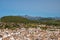 Scenic view of historic townscape and mountains against clear blue sky