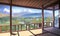 Scenic view on imaginary asian village from traditional looking balcony. Mountains in the background. Anime style digital