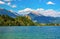 Scenic view of Lake Bled with castle on the rock and mountains covered by clouds on background at springtime, Slovenia