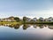 Scenic view of lake by trees against sky