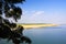 Scenic view from Lawkananda pagoda beyond tree on sandbank island - Irrawaddy River, Bagan, Myanmar