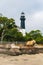 Scenic view of a lighthouse atop a beach in South Carolina, surrounded by trees