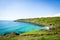 Scenic view of a lush hillside situated near a crystal-clear ocean