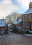 A scenic view of the main street in the village of heptonstall in west yorkshire with snow covering the old stone houses and