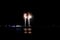 A scenic view of a majestic multicolor firework with reflection over the water under a majestic black sky