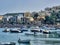 Scenic view of many luxury sailing fishing boat and charter rental speedboats moored at mountain harbor lake bay against mountain