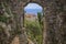 Scenic view of the Mediterranean coastline and medieval houses through a stone archway in Eze village the French Riviera