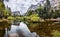 Scenic view of Mirror lake, along Tenaya Creek; Half Dome and surrounding mountain ridges reflected in the shallow, calm waters of