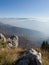 Scenic view from Mount Vlasic, a valley filled with fog and peaks above the fog in autumn during a sunny day