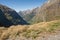 A scenic view of the Mountain in New Zealand - Mackinnon pass â€“ Milford track