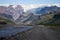 Scenic view Of Mountain Road Among Snowy Mountains nearby river in Thorsmork, Iceland