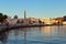 A scenic view of Muscat Corniche with the minaret of a mosque forming a beautiful reflection in the water