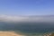 Scenic view of Nazare beach. Coastline of Atlantic ocean. Portuguese seaside town on Silver coast. The clouds above the water are