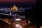 Scenic view of a night city with river, city lights an historical buildings