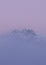 Scenic view of Nordkette mountain chain through the dense purple fog, Austria, Tirol, Innsbruck