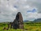 Scenic view of the old Jain Mandir temple in wilderness under white dense clouds, Anjaneri, India