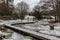 Scenic view over a wooden path through the Brussels wetlands, covered with snow in Molenbeek