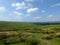 Scenic view of a path on the edge of moorland in calderdale west yorkshire with rough tussock grass with dry stone walls