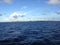 Scenic view of a peaceful ocean, with an expanse of crystal blue water with white clouds